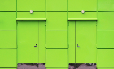 texture of bright green building with a blue roof utility room near the gas station.の写真素材