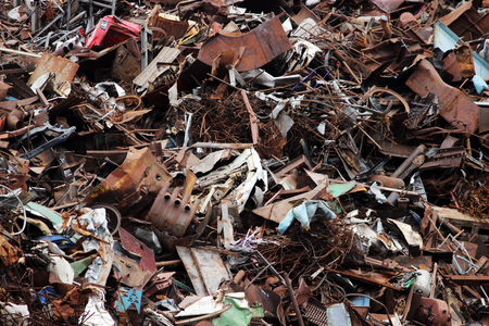 pile of scrap black metal piled in the open air.の写真素材