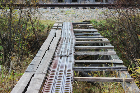 destroyed a bridge across the ditch from wooden planks and metal profilesの写真素材