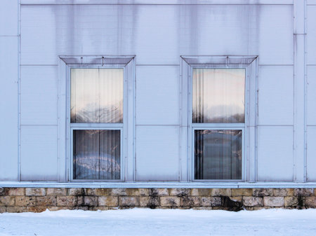 two rectangular windows with siding imitating steel, on large sports complex.の写真素材