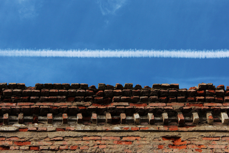 upper part of the old brick building against the skyの写真素材