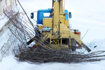 lift by which workers cut branches of trees lime trees in the park in winterの写真素材