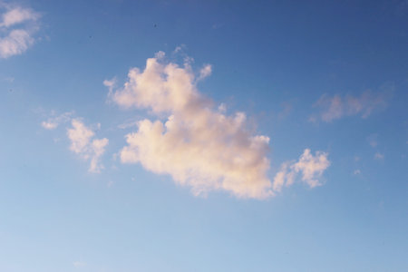 white clouds against the blue sky on a sunny winter day in the evening