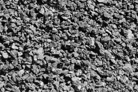 Black and grey shiny faceted pieces Charcoal background.の写真素材