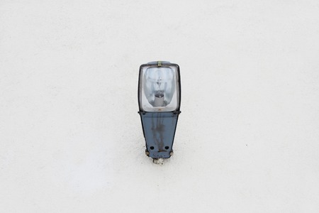 street lamp, built-in wall of a house on a beige backgroundの写真素材