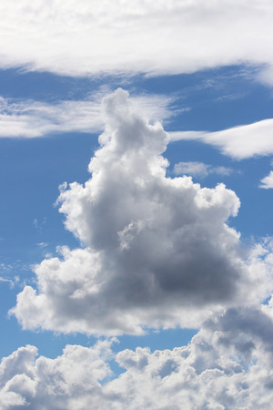 white clouds against a blue sky summer day.の写真素材