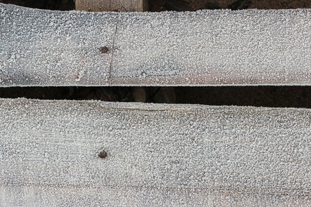 Footbridge on the ground to help walkers stay dry when crossing wet land. Frost on footbridge.の写真素材