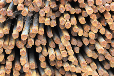 rusty rebar rods lie in a pile near the construction site of the viaduct.