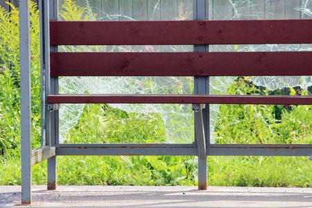 Vandals smashed the glass at a bus stop in the cityの写真素材