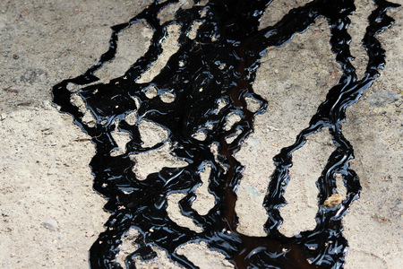 tracks of black tar are poured on the sand.の写真素材