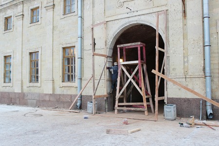 workers built wooden scaffolding for the restoration of the arch Gatchina Palaceの写真素材