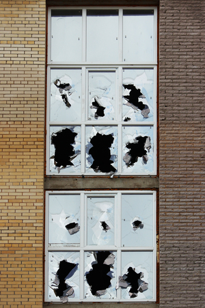 Vandals smashed the glass of windows of the an unfinished shopping mall, which was left without protectionの写真素材