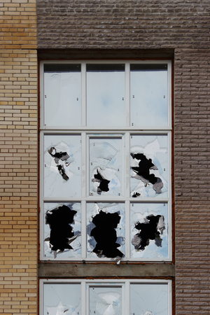 Vandals smashed the glass of windows of the an unfinished shopping mall, which was left without protectionの写真素材