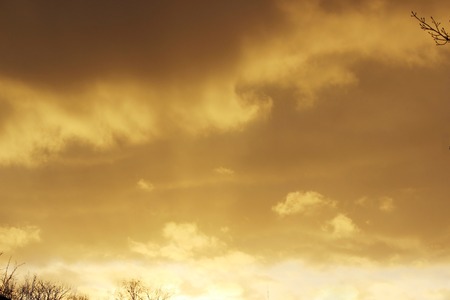 snow cloud painted in gold color of the setting of the spring sunの写真素材