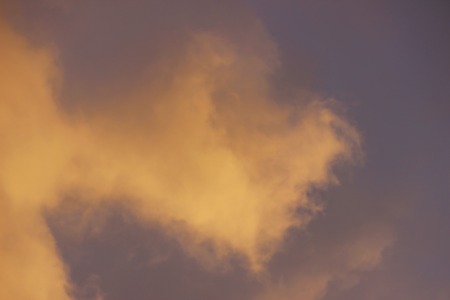 snow cloud painted in gold color of the setting of the spring sunの写真素材