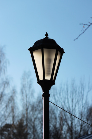 Lantern in the park in the spring sunlit by the sunの写真素材