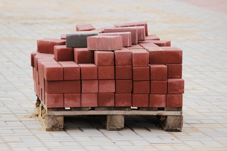 Red paving slabs folded on a pallet during the reconstruction and repair of the square in the cityの写真素材