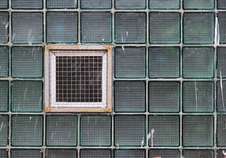 A window in a glass wall made of thick-walled batch cells.の写真素材