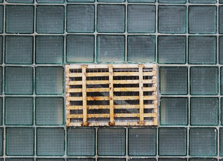 A window in a glass wall made of thick-walled batch cells.の写真素材