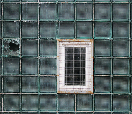 A window in a glass wall made of thick-walled batch cells.の写真素材