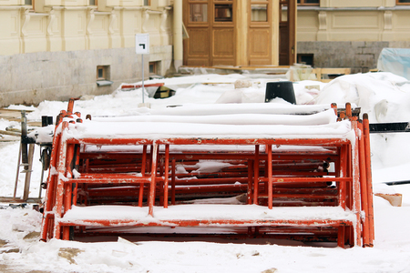 disassembled scaffolding in the form of tubes, painted in red paint lie on the construction site for the restoration of the palace.の写真素材