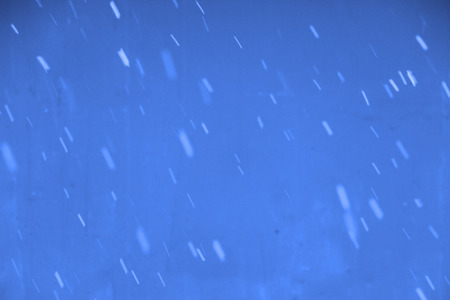 Falling snow flakes during the snowfall from the sky.の写真素材