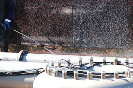 A worker washes the fountain with a portable washing machine in the spring, St. Petersburgの写真素材