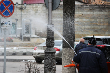 Cleaning the dirty post in the city post with high pressure washer in the springの写真素材