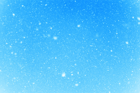 Falling snow flakes during the snowfall from the skyの写真素材