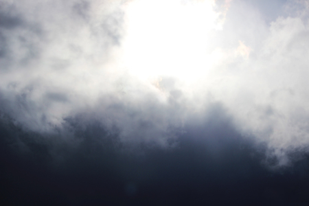Huge white cumulus clouds against dark blue sky in springの写真素材