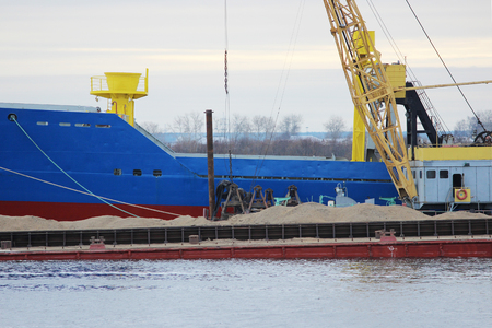 Blue cargo ship and barge with cargo on the river Severnaya Dvinaの写真素材