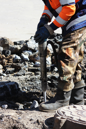man working a jackhammer on a city street.の写真素材