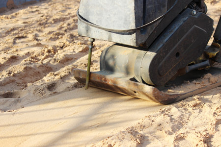 Vibro roller for compacting sand before laying paving slabs during the repair of the sidewalk in the...