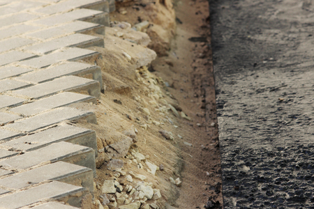 Asphalting of territory at a trading-office complex with the dismantling of paving slabs, which was laid beforeの写真素材