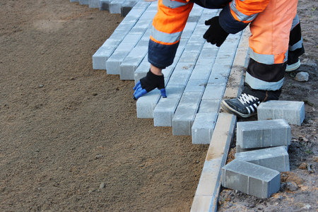 Repair of the sidewalk. Worker stonemason repair the sidewalk for Laying paving slabの写真素材