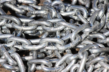 pile metal silver chain lies on the asphalt in the parking carの写真素材