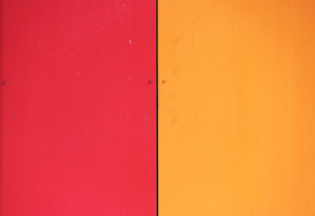 The wall of the house, trimmed with colorful panels, painted in bright colors. Red and orangeの写真素材