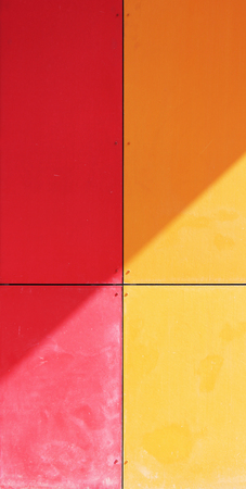 The wall of the house, trimmed with colorful panels, painted in bright colors. Red and orangeの写真素材
