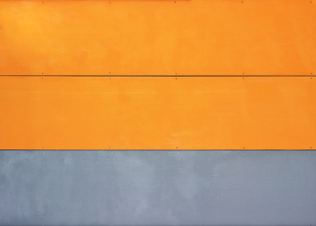 The wall of the house, trimmed with colorful panels, painted in bright colors. Grey and orangeの写真素材