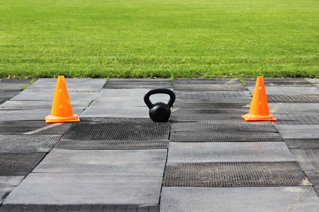 Plastic orange signal cones stand at the stadium in preparation for the competition for lifting weights.の写真素材