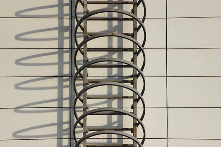 Fire escape and shadow on the wall of an office building.の写真素材