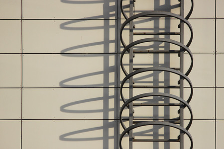 Fire escape and shadow on the wall of an office building.の写真素材