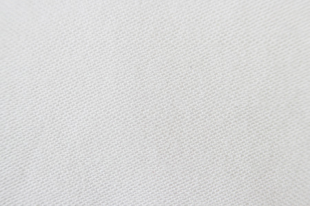 Macro texture of light beige fabric with machine seam.の写真素材