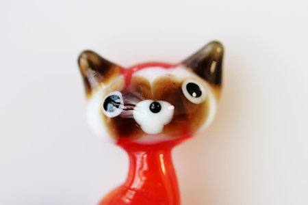 Macro photo of a small sculpture of a glass cat on a white backgroundの写真素材