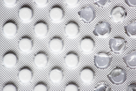 Macro photo many white small tablets in blister push-trough packの写真素材