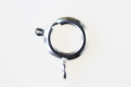 Aluminum buckle for chains and necklaces in disassembled form on a white background. macro.