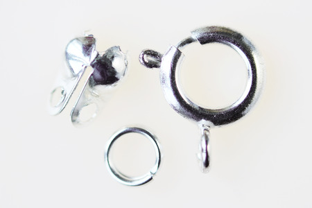 Aluminum buckle for chains and necklaces in disassembled form on a white background. macro.の写真素材