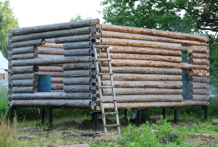 Assembling a wooden frame and building a house. Russia. Texture of old wooden logsの写真素材