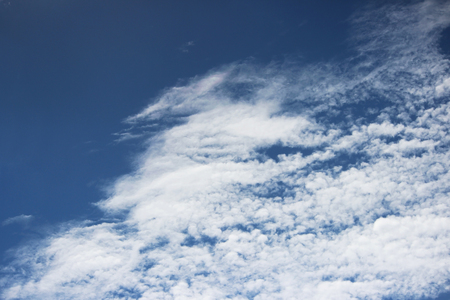 white clouds against the blue sky on a sunny summer dayの写真素材