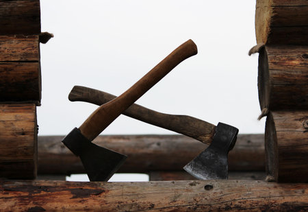 Two axes on the when building a wooden house are ready for work.